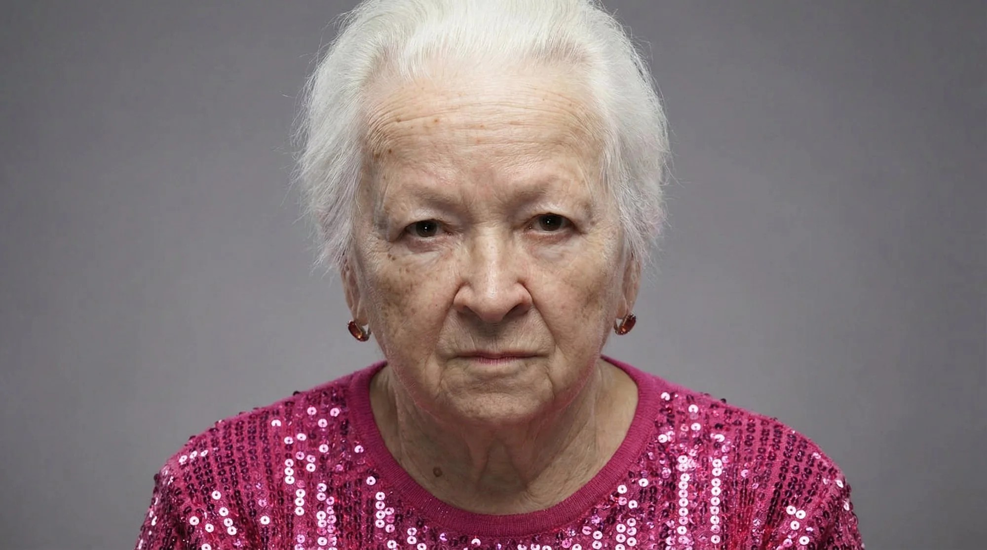 Generated: the examiner in a pink sequin sweater, studio portrait