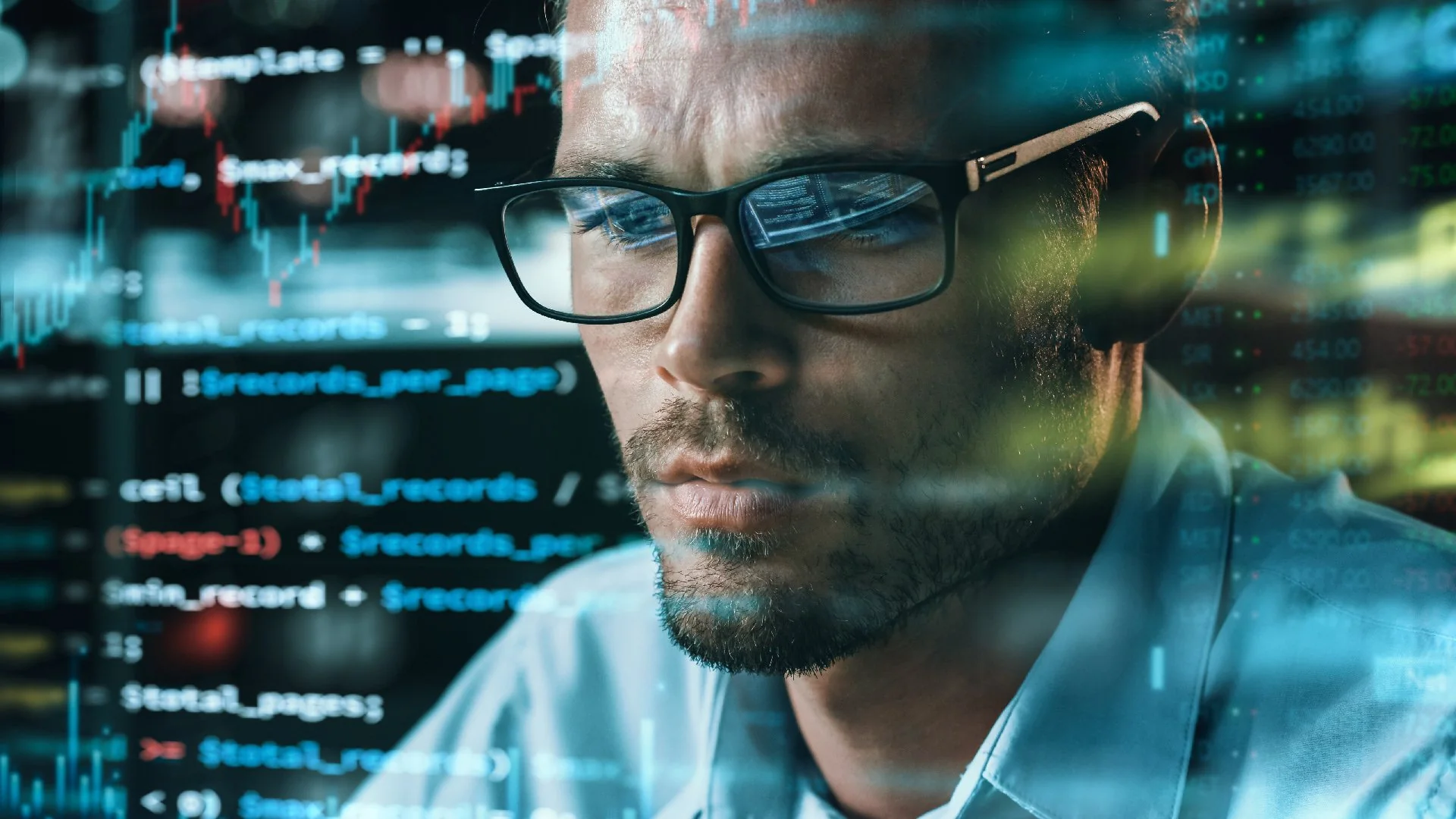Developer in glasses with code reflected on the lenses