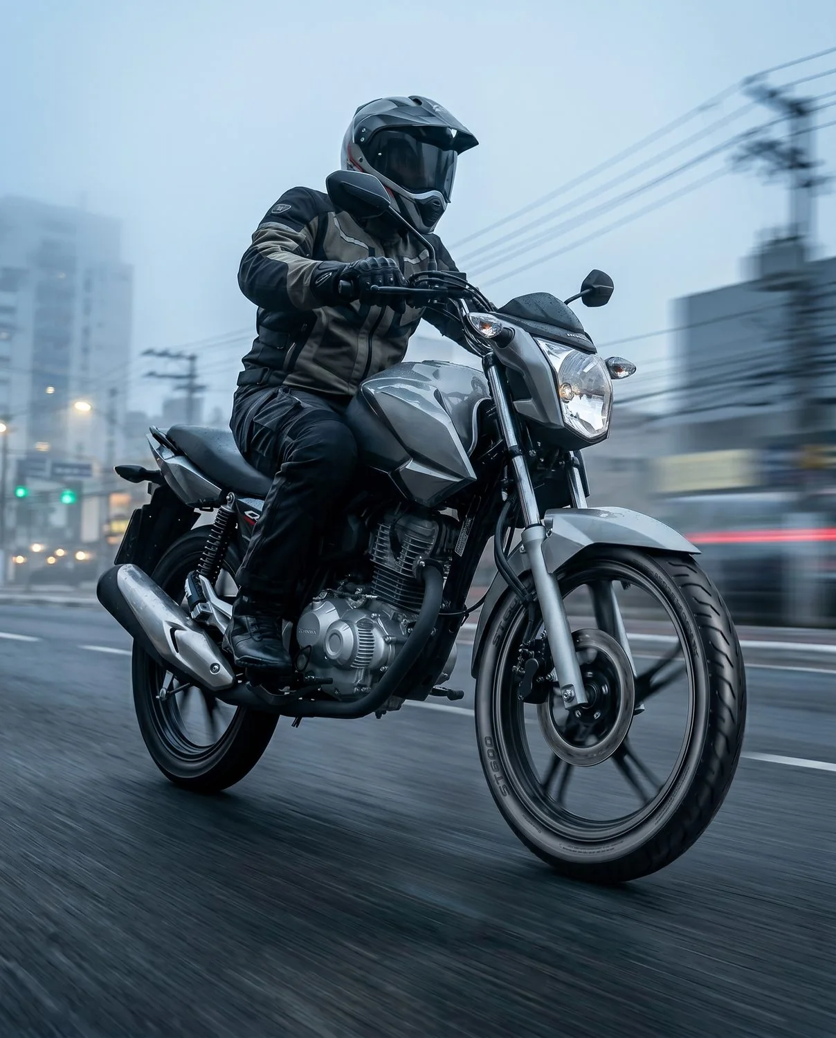 Rider on a Honda CG on a city avenue