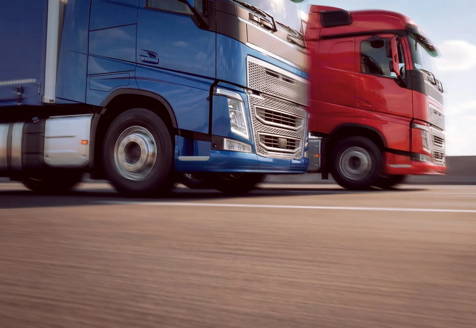 Reference photo of blue and red trucks on a highway