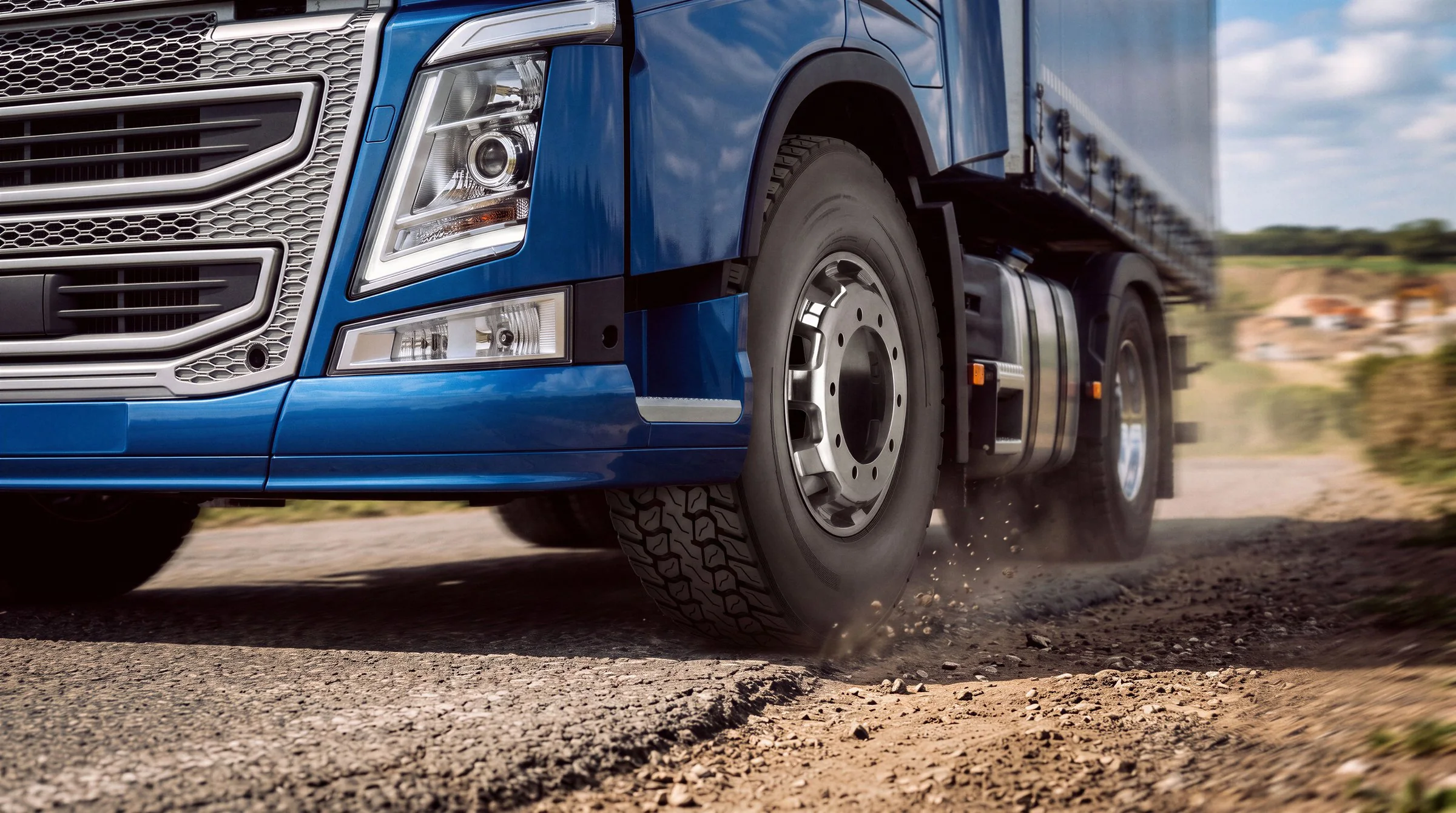Final: truck tire moving from asphalt onto gravel