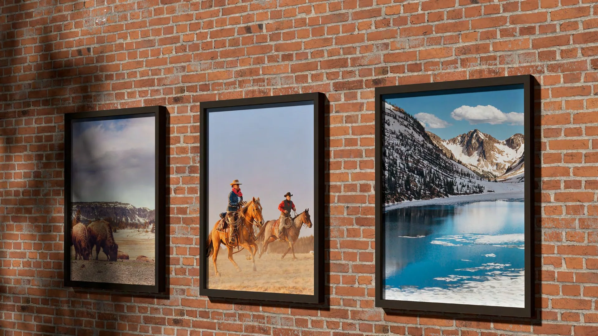 Framed Western photographs on a brick wall