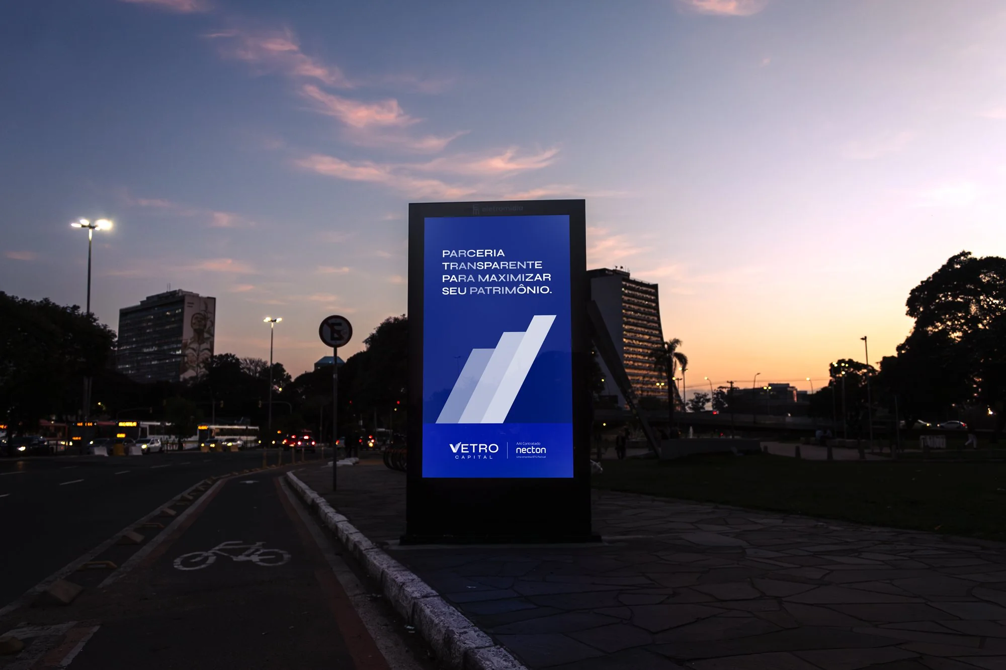 Vetro Capital digital totem on a Porto Alegre avenue at dusk